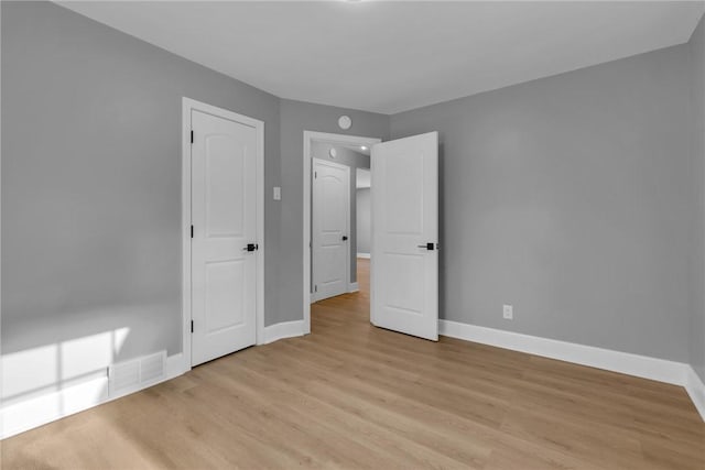 unfurnished bedroom featuring light wood-type flooring