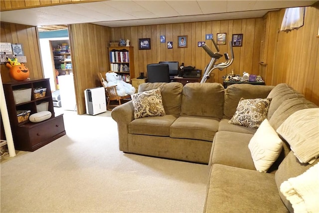 living room featuring carpet and wooden walls