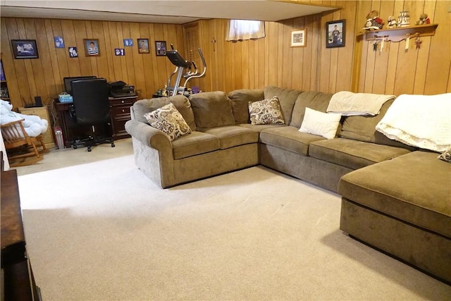 living room featuring light colored carpet and wooden walls