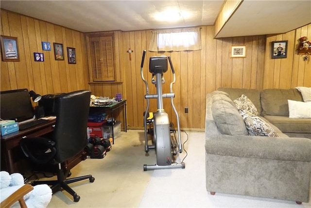 office space with light carpet and wood walls