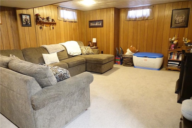 living room featuring carpet and wood walls