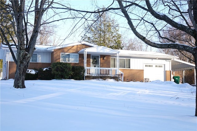 single story home with covered porch, a garage, and a carport