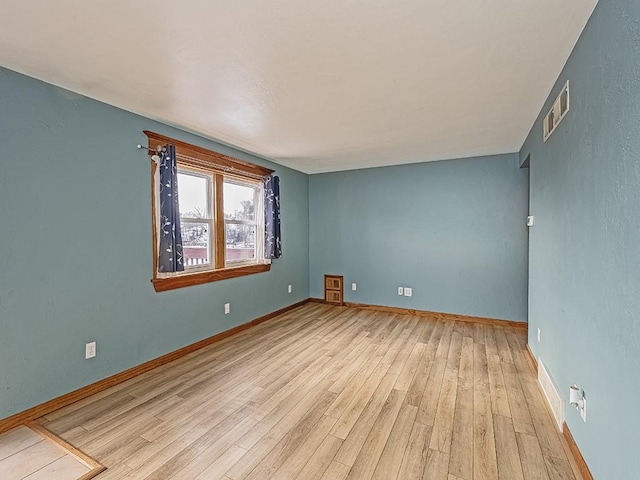 unfurnished room with light hardwood / wood-style flooring