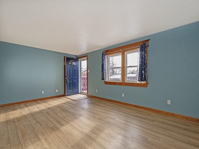 empty room with light hardwood / wood-style flooring