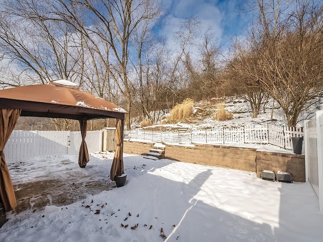 snowy yard with a gazebo