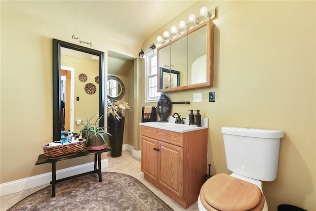 bathroom featuring tile patterned floors, vanity, and toilet