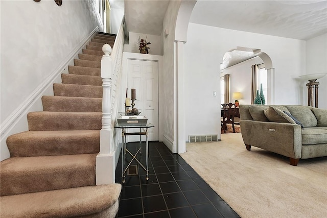 staircase featuring carpet floors