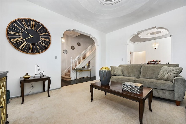 carpeted living room with a chandelier