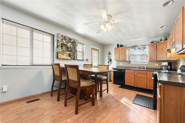 kitchen featuring ceiling fan, tasteful backsplash, dishwasher, light hardwood / wood-style flooring, and sink