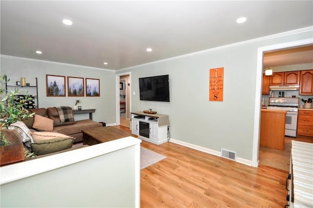 living room featuring light wood-type flooring and ornamental molding