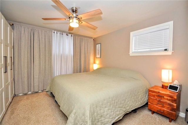 bedroom featuring light carpet and ceiling fan