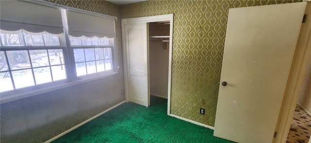 unfurnished bedroom featuring a closet and dark carpet