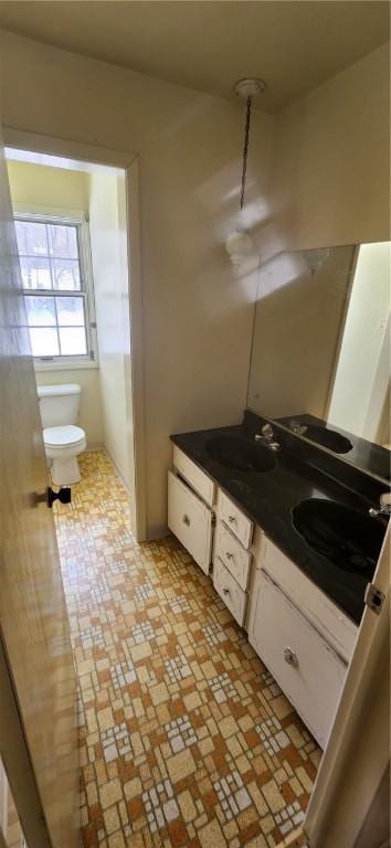 bathroom featuring toilet and vanity