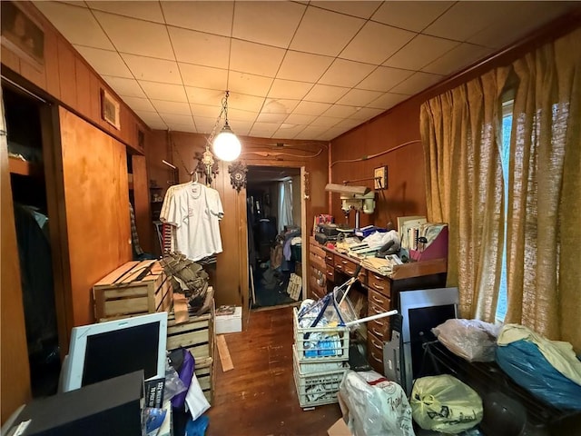 misc room featuring dark hardwood / wood-style flooring and wood walls