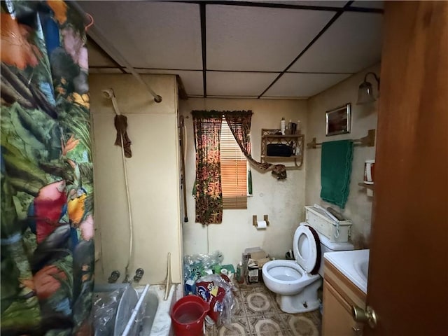 full bathroom featuring shower / bathing tub combination, a drop ceiling, toilet, and vanity