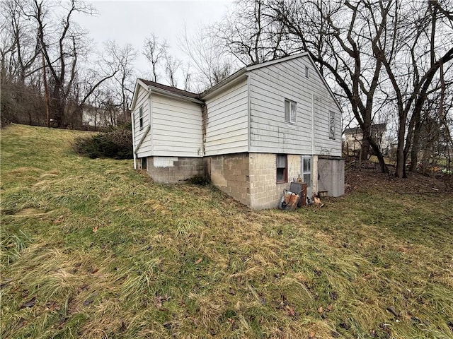 view of side of home featuring a yard