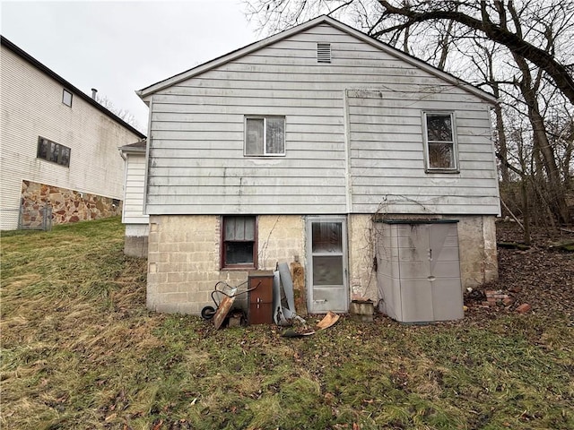 rear view of property with a yard