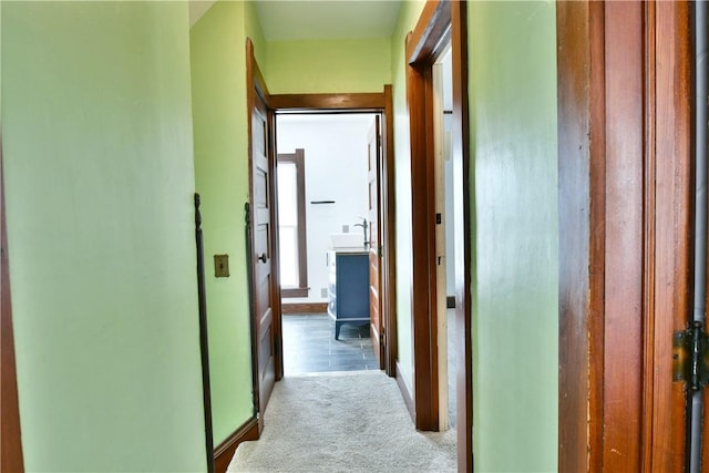 corridor with sink and light carpet