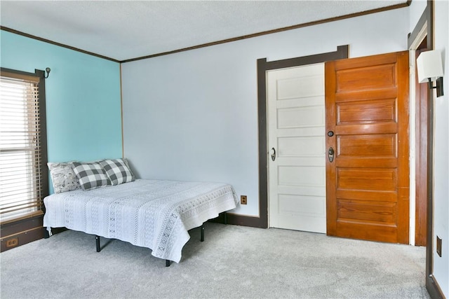 carpeted bedroom featuring crown molding