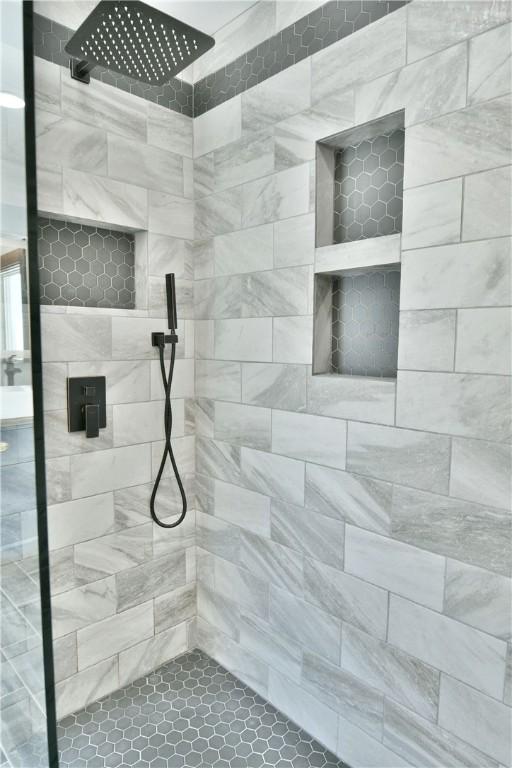 bathroom with tiled shower