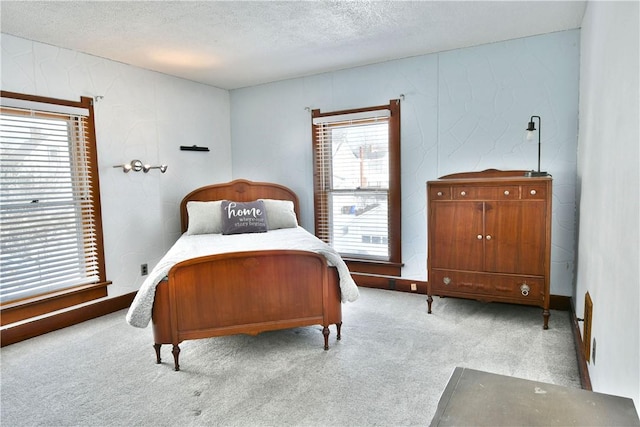 carpeted bedroom with a textured ceiling