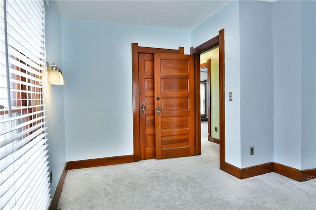 spare room featuring light colored carpet