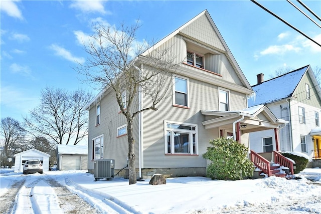 view of front of property featuring an outbuilding, central AC unit, and a garage