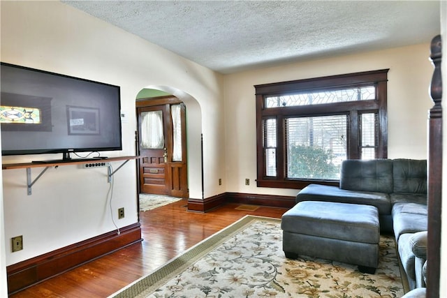 sitting room featuring a textured ceiling and dark hardwood / wood-style flooring