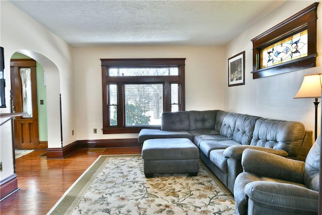 living room featuring a textured ceiling and hardwood / wood-style floors