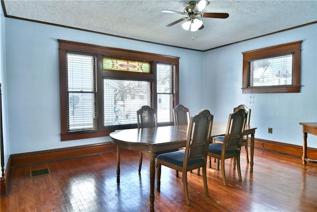 dining area with ceiling fan, plenty of natural light, a textured ceiling, and hardwood / wood-style flooring