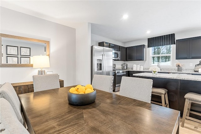 dining area featuring light wood-style floors and recessed lighting