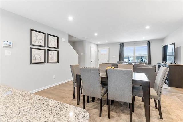 dining space featuring light wood-style floors, recessed lighting, and baseboards