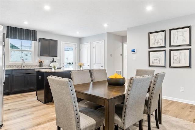dining space featuring light wood-style floors, baseboards, recessed lighting, and visible vents