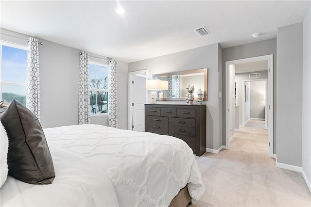 bedroom with light colored carpet, baseboards, and visible vents