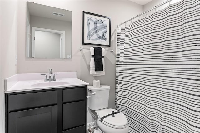 bathroom featuring vanity, visible vents, toilet, and a shower with curtain