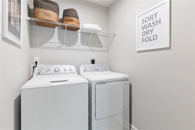 clothes washing area featuring laundry area and washer and clothes dryer