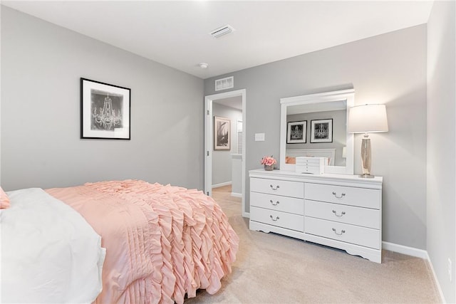 bedroom with visible vents, baseboards, and light carpet