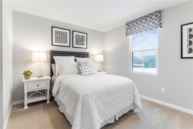 bedroom with carpet floors and baseboards