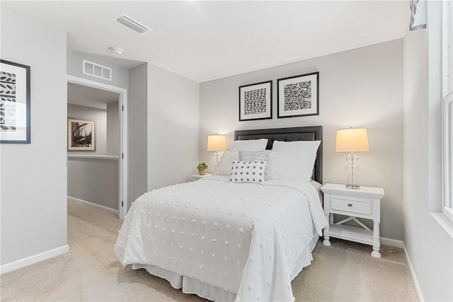 carpeted bedroom with baseboards and visible vents