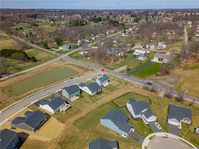 drone / aerial view with a water view and a residential view