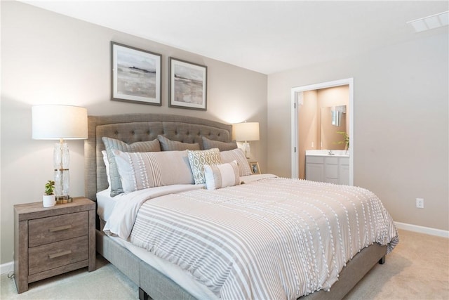 carpeted bedroom featuring ensuite bathroom