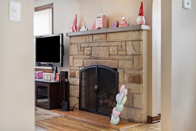 interior details featuring wood-type flooring and a fireplace