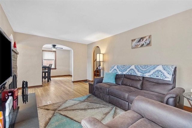 living room featuring ceiling fan and light hardwood / wood-style flooring