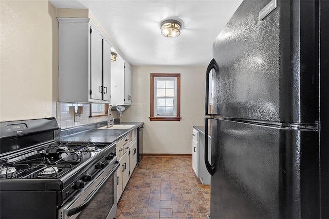 kitchen featuring sink, white cabinets, black appliances, and tasteful backsplash