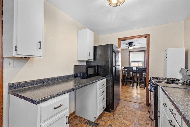 kitchen featuring ceiling fan, white cabinets, and stainless steel gas range