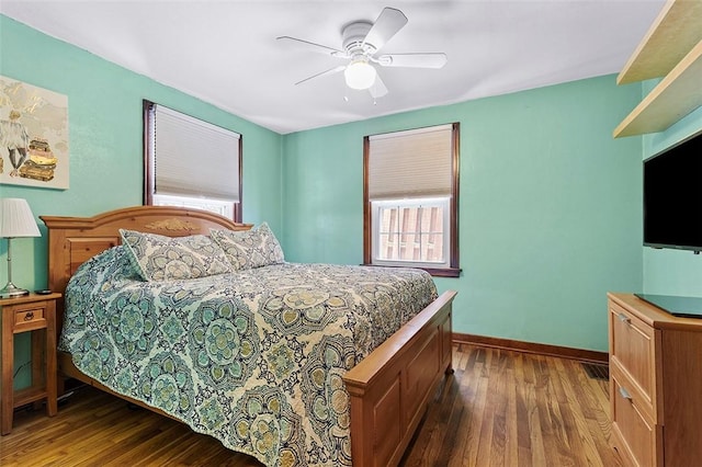 bedroom featuring ceiling fan and dark hardwood / wood-style floors