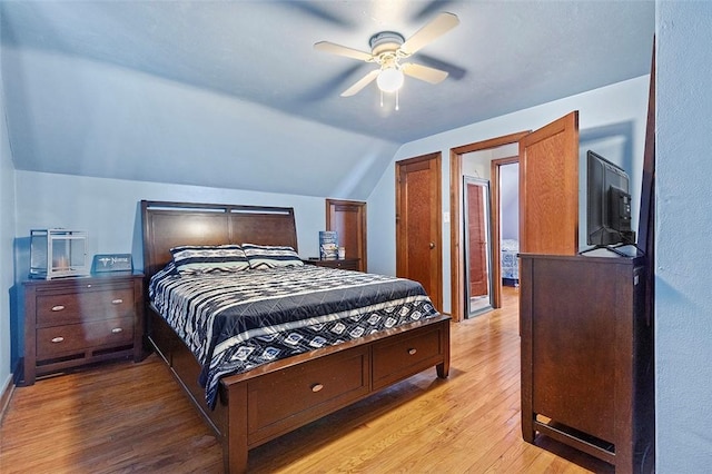 bedroom featuring ceiling fan, light hardwood / wood-style flooring, and vaulted ceiling