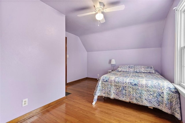 bedroom featuring ceiling fan, vaulted ceiling, and light hardwood / wood-style flooring