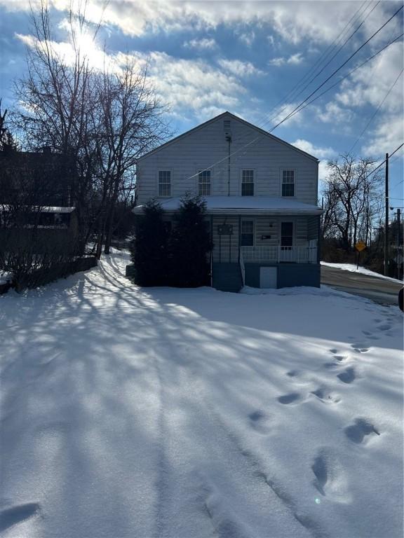 view of snowy exterior featuring a porch