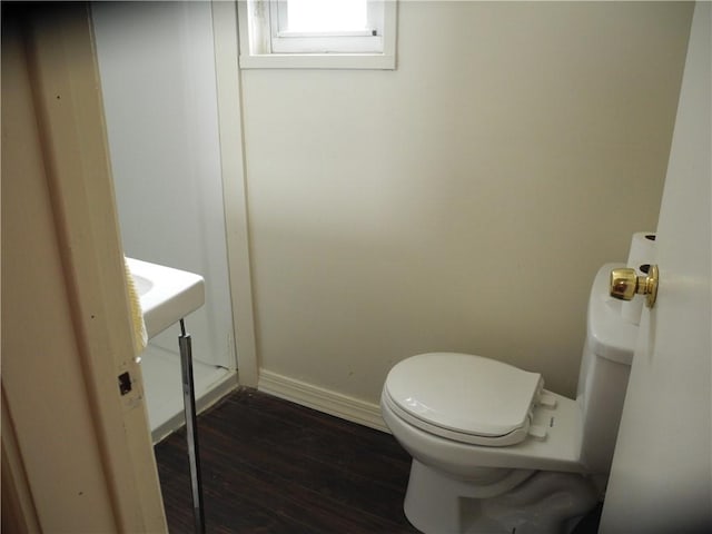 bathroom with toilet and hardwood / wood-style floors